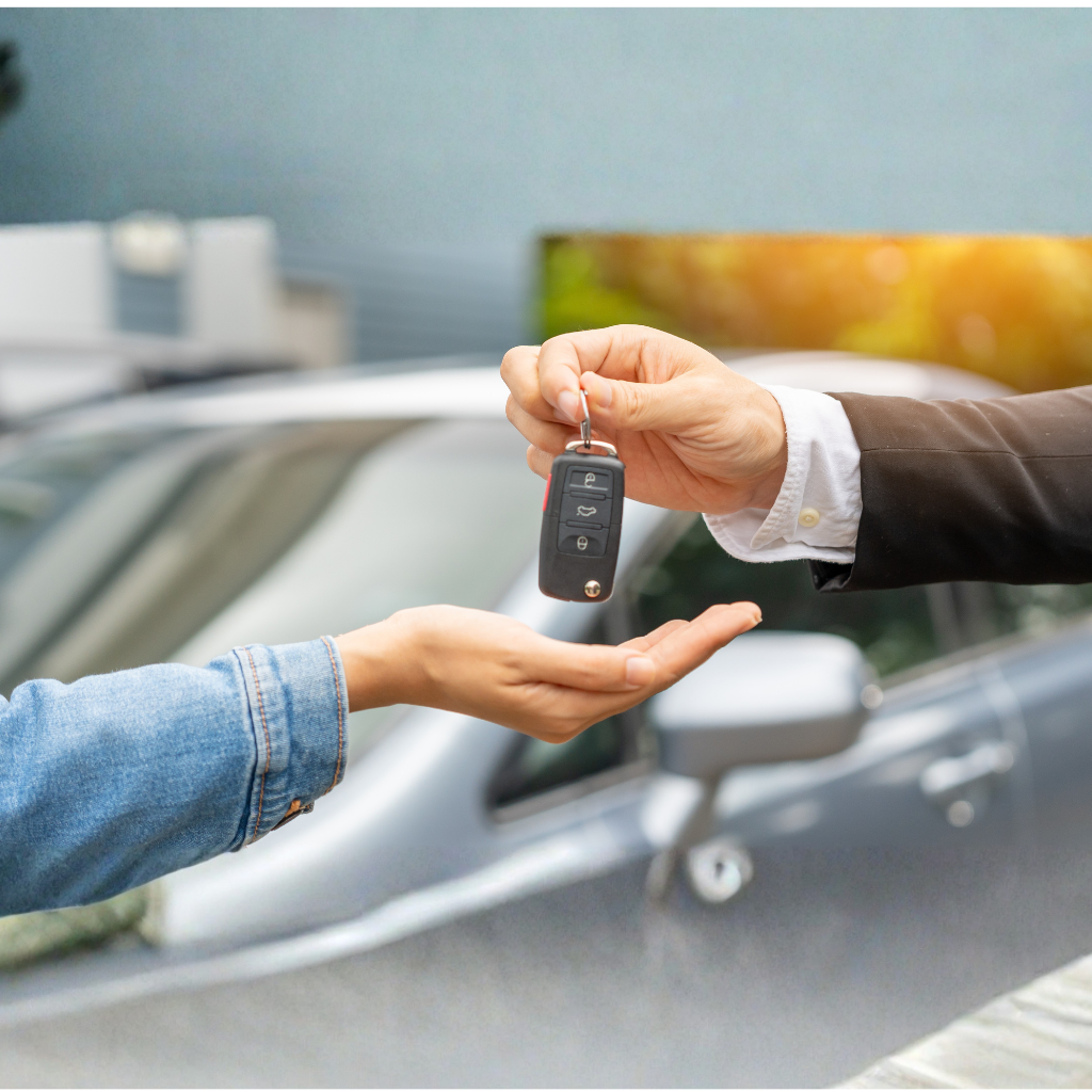 handing over car keys, car in background